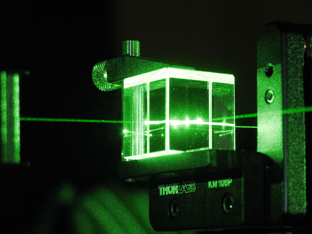 According to quantum mechanics, no one can predict whether a photon will be reflected by or transmitted through a piece of glass, not even in principle. It's fundamentally random.