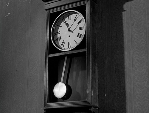 A pendulum swings back and forth to mark time.