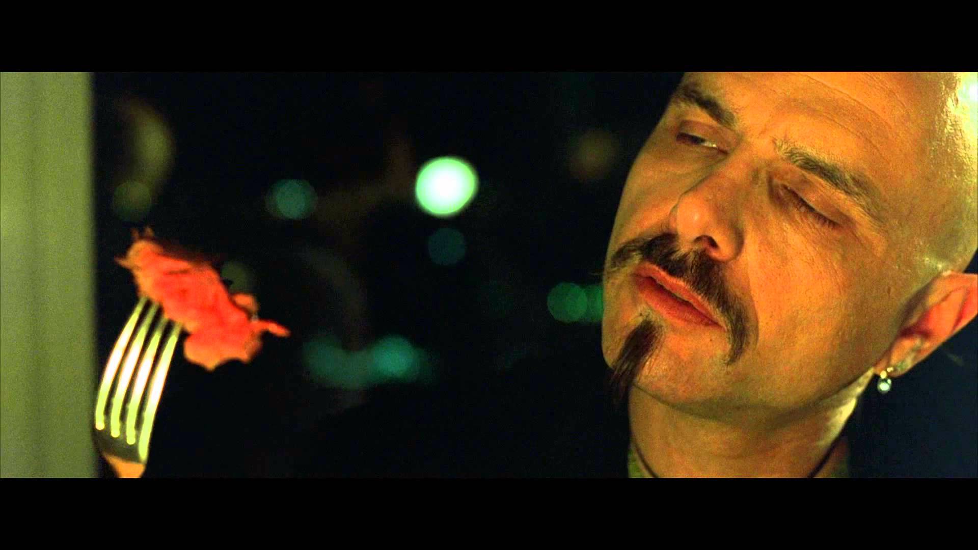 Cypher enjoys a simulated meal in The Matrix (1999)